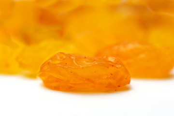 Gold yellow raisins close up isolated on white background