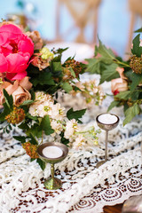 Candles and flowers on a vintage lace