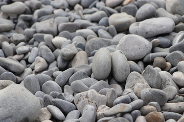 Smooth grey pebbles on the beach