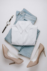 Women's clothing on a pale background. Flat lay and top view
