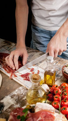 young chef hands preparing the ingredients for homemade traditional pizza