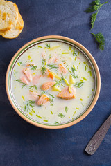 Salmon soup. Creamy hearty salmon fish soup. Clean eating, healthy and diet food concept. View from above, top studio shot