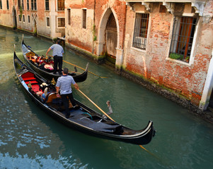 Fototapeta premium Two Gondolas navigating small Venice Canal.