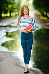 Positive and cute blond girl posing at the park