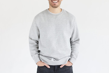 Template of young man in gray sweatshirt, standing isolated on background. No face photo