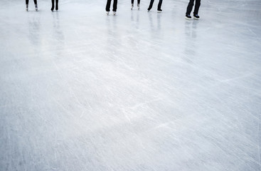 group of people skating on ice in an outdoor park