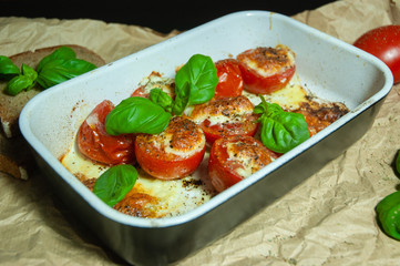 Closeup detail look on fresh vegetarian sliced and salted tomatoes ready to bake covered with...