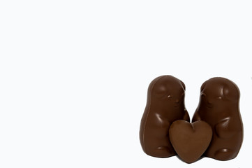 pair of chocolate bears with chocolate heart on a white background love Valentine's day isolate
