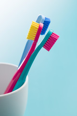 Colorful toothbrushes in cup.