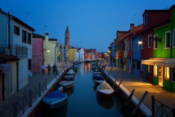 Fototapeta na wymiar Old colorful houses and boats at night in Burano, Venice Italy.