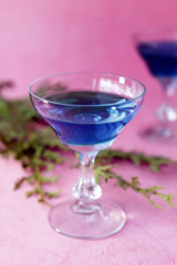 Blue curacao alcohol coctail on a pink background