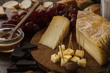 French cheese Tom de Savoie still life on wooden table