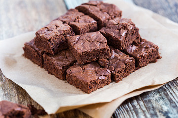 Pieces of freshly baked chocolate brownie on rustic wooden board