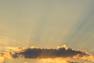 Landscape with dramatic light - beautiful golden sunset with saturated sky and clouds.