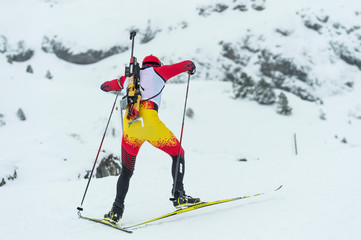 Winter sports. A participant in a biathlon competition, in a winter season in Spain, in a snowy...