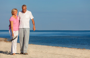 Happy Senior Couple Walking Laughing on a Beach