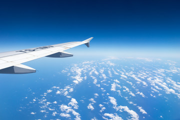 Fototapeta na wymiar Airplane flying above clouds, Mediterranean Sea