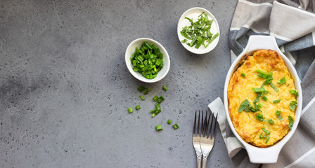 Potatoes casserole with cheese and green onion served with sour cream and mint. Vegetarian food. Copy space.