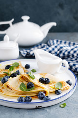 Sweet pancakes wrapped with fresh berries, crepes with blueberry