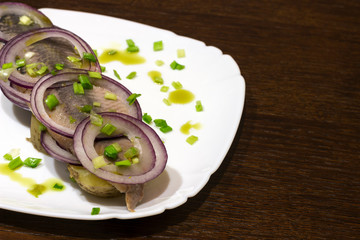 copy spaсe, herring with boiled potatoes and fresh onions on a plate, close-up