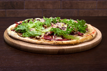 pizza on the table in a wooden plate