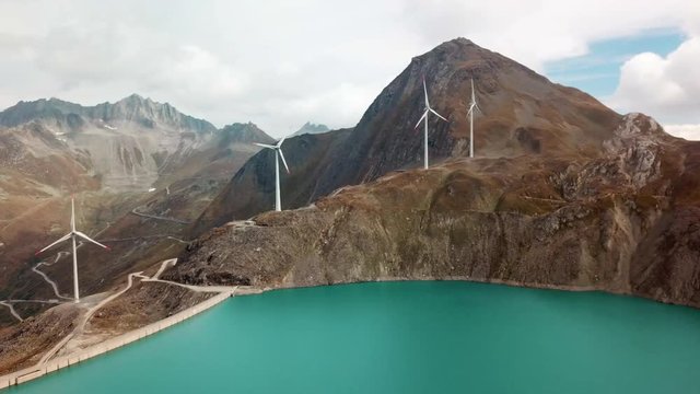 Griessee reservoir on the Nufenen Pass with wind turbines