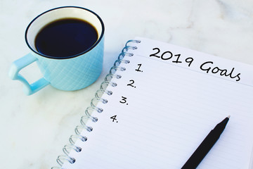 2019 goals list with cup of coffee on a marble background.