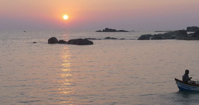 Two Fishermen Laying Nets from Boat at Sunset, Canacona, Goa, India