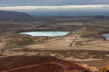 Landscape with geothermal zone in storm with lake and building, Krysuvík, Iceland