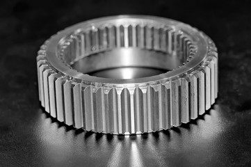 Industrial gear on black background. Black and white toned image