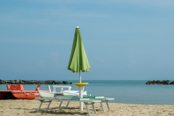 Two lounge chairs and lifeboats on the San Benedetto del Tronto Beach, Adriatic Sea, Ascoli Piceno, Italy