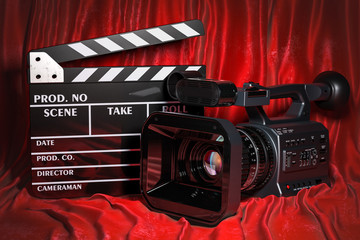 Fototapeta premium Cinema concept. Movie camera with clapperboard on the red fabric, 3D rendering