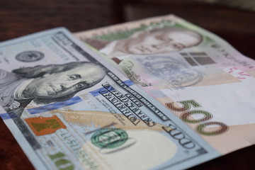 Ukrainian money - 500 hryvnia banknotes USA 100 dollars bills. Finance crisis in Ukraine, the fall of the hryvnia to the dollar exchange rate. Money background