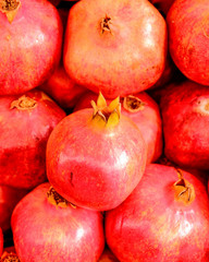 raw pomegranates top view closeup, natural background
