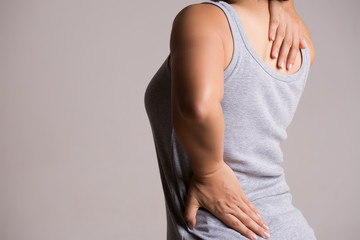 Close up woman having pain in injured back. Healthcare and back pain concept.