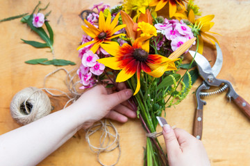 Florist workplace. Flowers and tools to create a bouquet on a table	