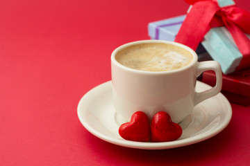 Good morning with hot coffee, lattee, capuccino drink ored background with red heart for your love, valentine's day concept. Gift boxes, surprise.
