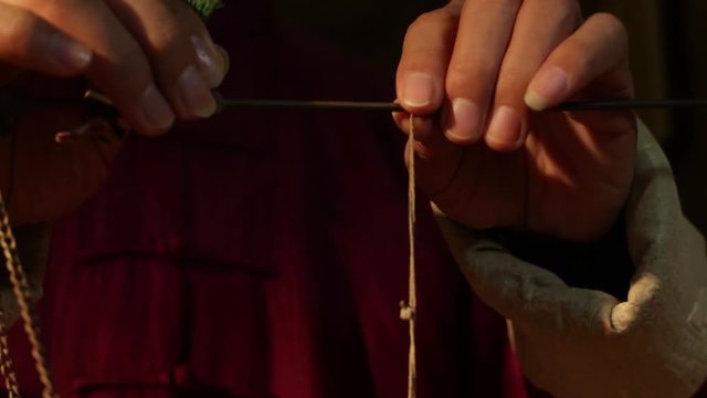 The old Chinese medicine in the pharmacy is weighing the weight of Chinese herbal medicine with a scale.