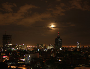 Fototapeta na wymiar Clouds in dramatic scene on blue blood moon night in Mexico City