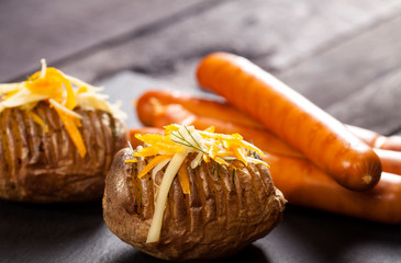 Baked stuffed potatoes with cheese, cheddar, dill and wiener sausages