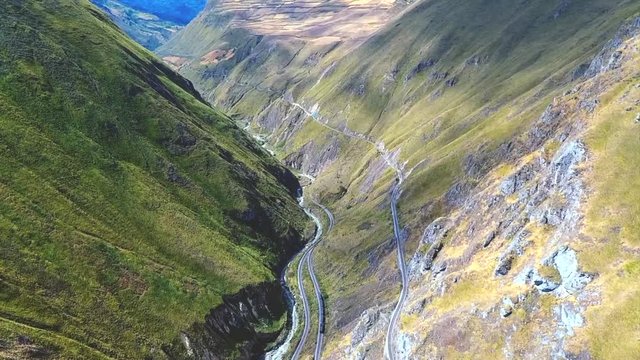 An aerial shot of a train going around the "Nariz del Diablo" or  Devil's Nose in Alaus&radic;&ne;, Chimborazo Province, Ecuador. The Devil's Nose is one of the world's most picturesque and dangerous railways.