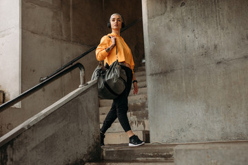 Female athlete walking inside a stadium