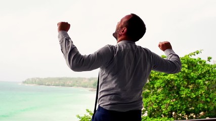 Young businessman using modern laptop and tablet on terrace, with sea view
- Powered by Adobe