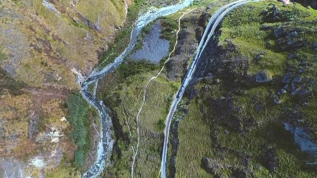An aerial shot of a train going around the "Nariz del Diablo" or  Devil's Nose in Alaus&radic;&ne;, Chimborazo Province, Ecuador. The Devil's Nose is one of the world's most picturesque and dangerous railways.