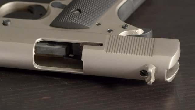 Open and empty pistol, tilting from grip to chamber