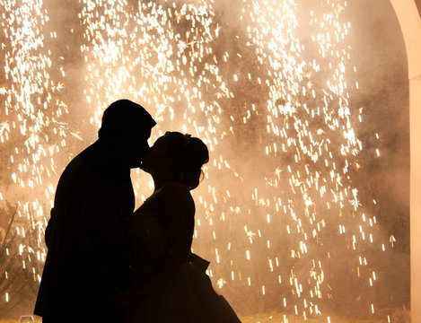 silhouette couple of newlyweds kissing while dancing on the dance floor celebrating valentines day