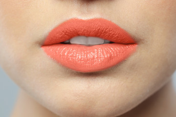 Obraz premium Young woman wearing beautiful lipstick, closeup view