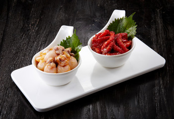 Japanese cuisine, octopus on the wooden background.