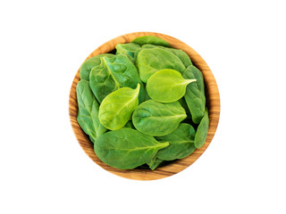 Spinach leaves in the olive wood bowl top view