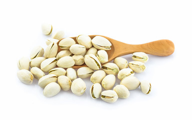 Pistachio in wooden spoon isolated on white background